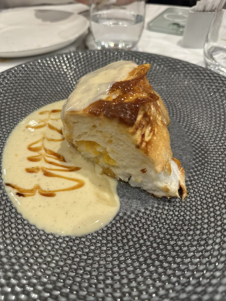 Souflé de melocotón acompañado con crema de vainilla servido como postre en Restaurante El Pincelín, Almansa.